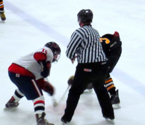 Senior Sam Persian takes a face off during a game versus Hutchinson. The boys went on to defeat them 8-1.