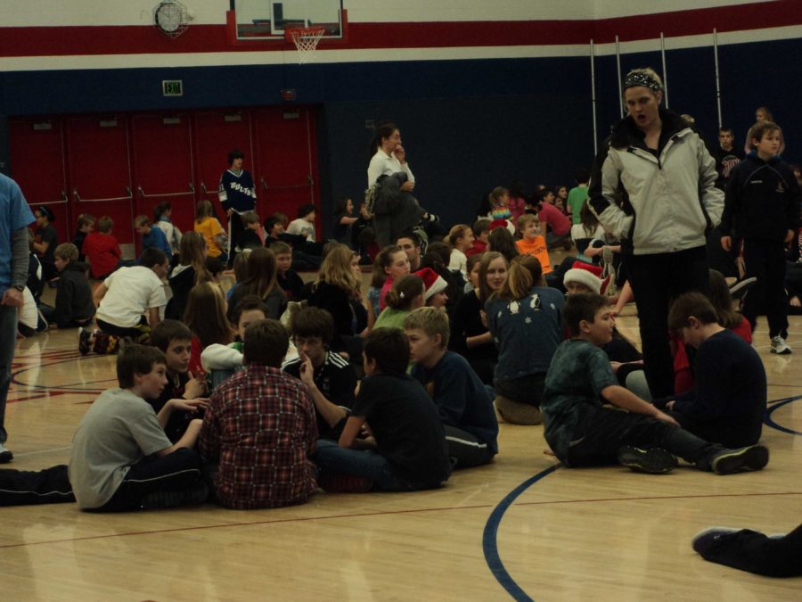 The middle school students congregate with their advisories in the high school gym.