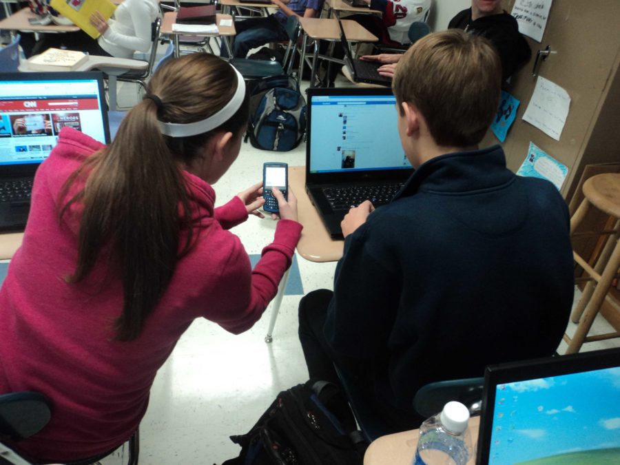 Students use computers and cell phones to research information for class and recreation.