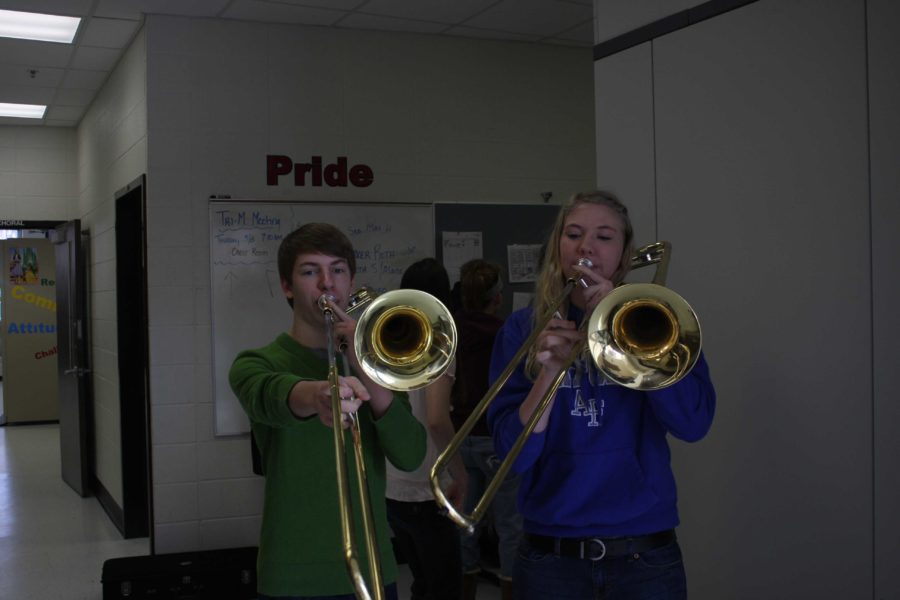 Adam Aasen and Emily Meyer practice playing the trombone in preparation for a recording session. Photo/ Andrea Conover