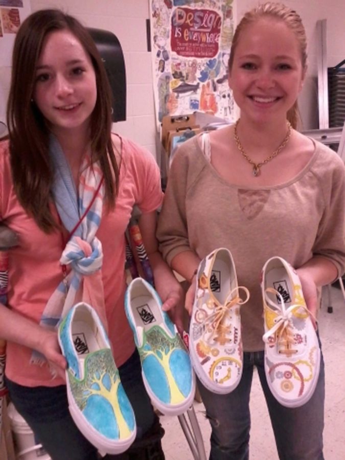 Students+Maddie+Mayhew+and+Taylor+Werdel+show+off+their+winning+shoe+designs.+Their+designs+were+sent+to+be+judged+by+the+nation.+Photo%2F+Sidney+Fairbrother