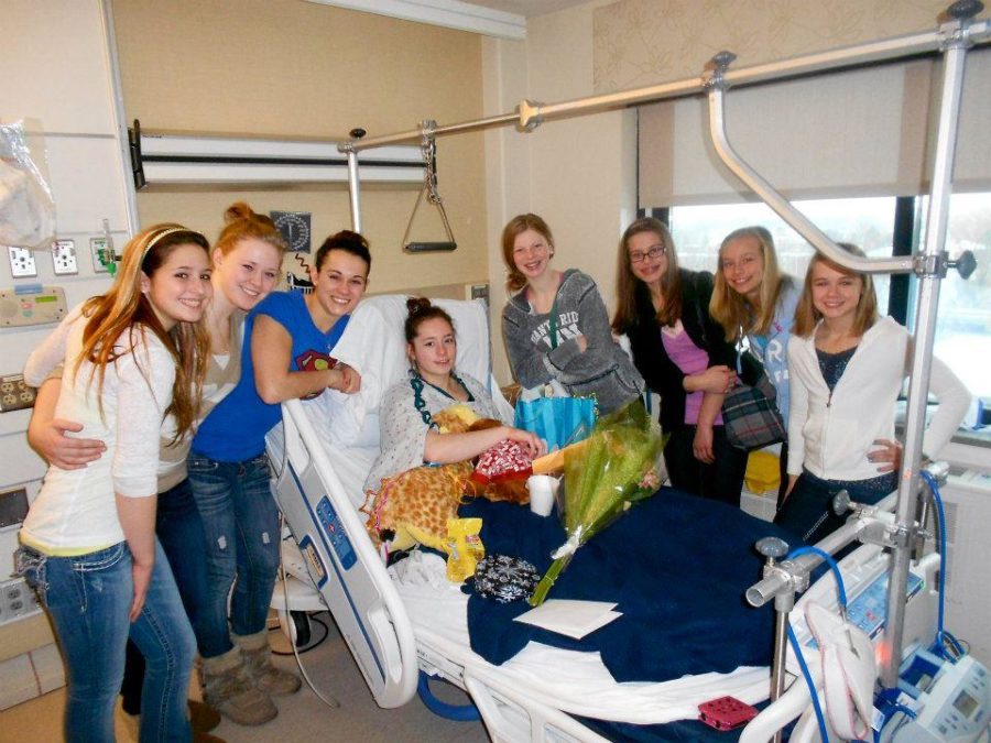 Mayhews team mates from North Shore Gymnastics visit her in the hospital after her injury. Photo courtesy of Kayla Roiland