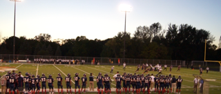 The varsity squad looks on as the offense goes for 3rd and 5

Photo/ Woody Hust