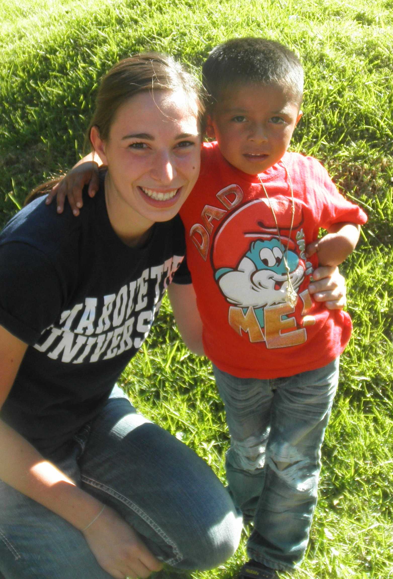 Junior Lydia Winkels smiles with Joshua, who she sponsors through Common Hope.