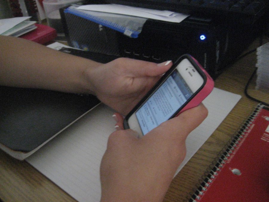 Senior Samantha Hartmann checks Facebook on her iPhone during study hall.