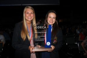 Heidorn and McCuskey receive their 2nd place trophy at the International DECA Conference in Anaheim, Ca. 