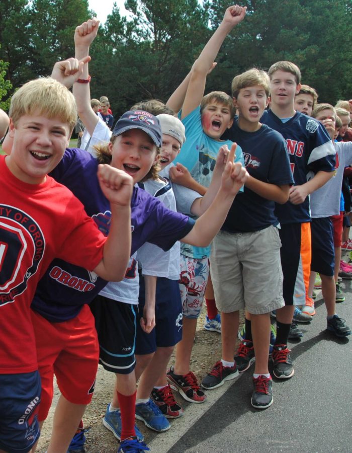 Photo/ Jack Ellis
7th grade boys are pictured cheering and waving to the passing floats during the homecoming parade. 
