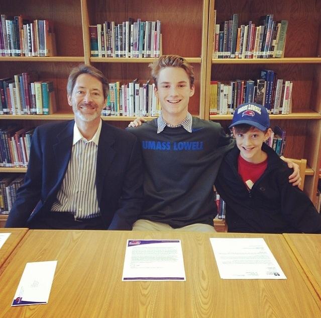 Senior Chandler Sampson (middle) signs to play lacrosse for UMass-Lowell with his father, Gregg Sampson (left) and younger brother,Campbell Sampson (right)