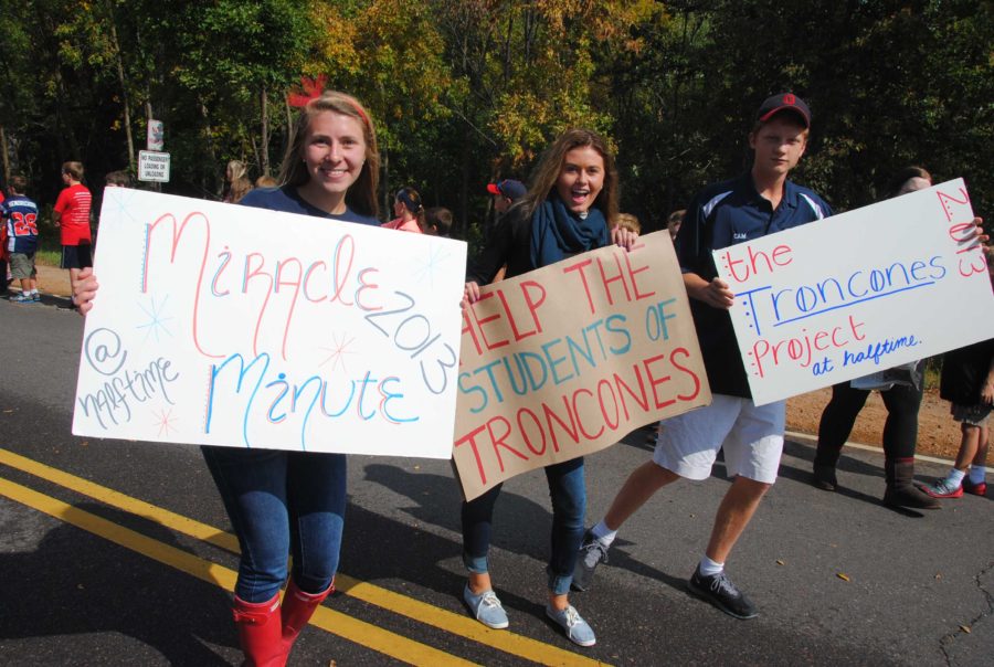 Seniors Eloise Hrusovsky (L), and Cam Knusten (R) and junior Lania Gustafson (C) marching for Tuition for Troncones.  