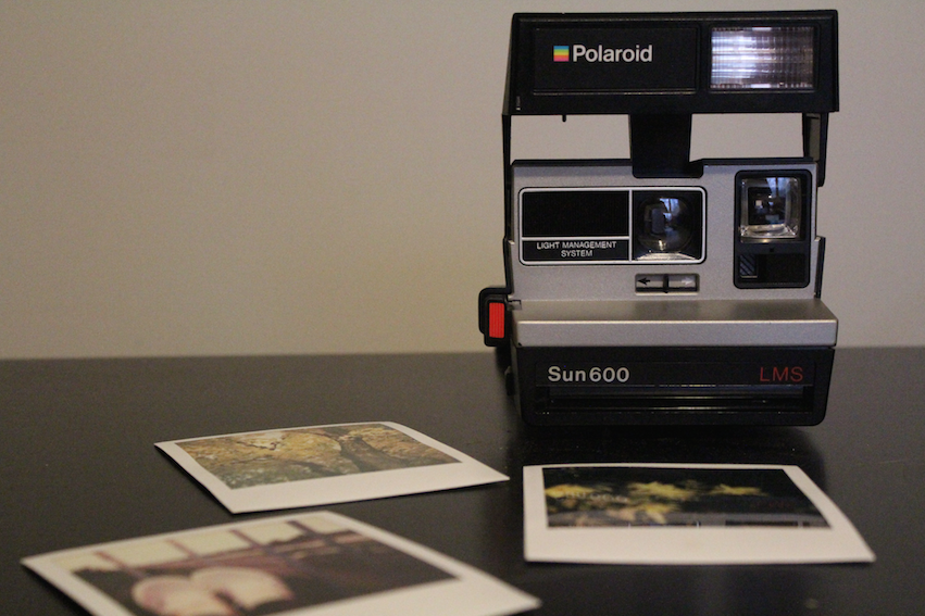 A+Polaroid+camera+and+a+few+pictures.