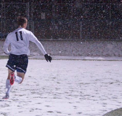 The boys soccer team fought the snow during the game.