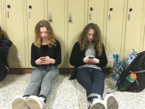 Students on their phones before school.