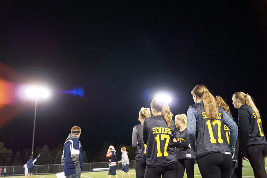 Senior ladies gaze onto the field. 
