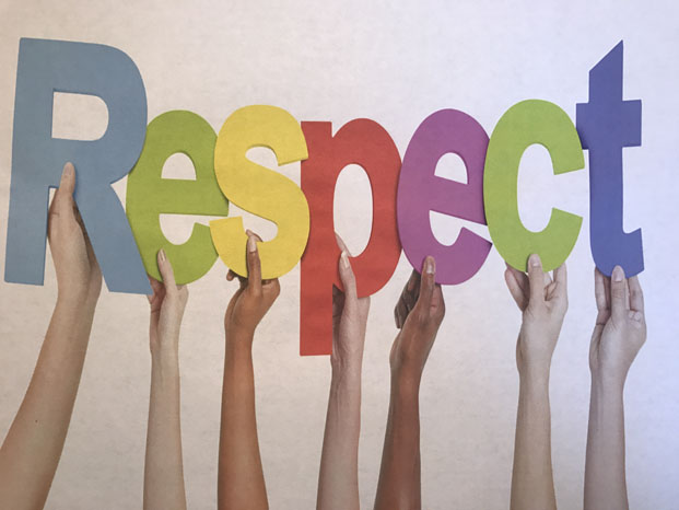 A poster depicting students holding up letters spelling respect. 