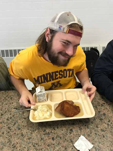 Senior Cody Quast enjoys his three pork chops. 