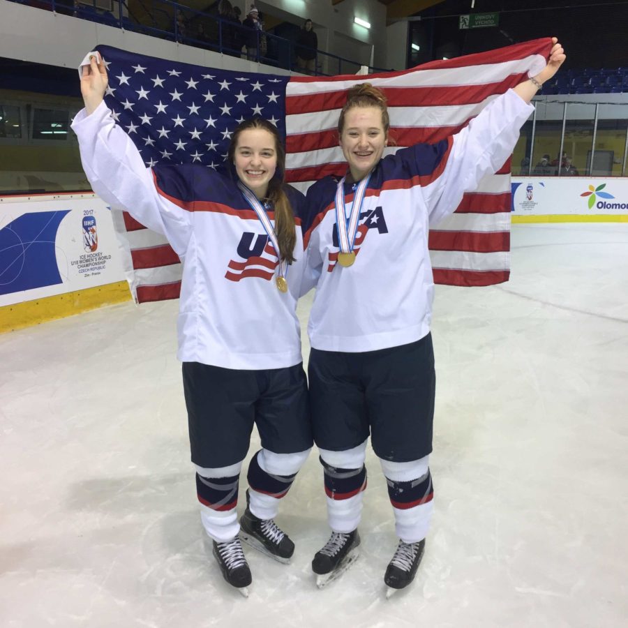Norton and a teammate celebrate with their gold medals.