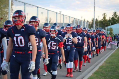 The football team marches to the field on Oct. 13.