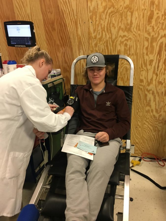 Landon Wittenberg giving blood at the blood drive. 