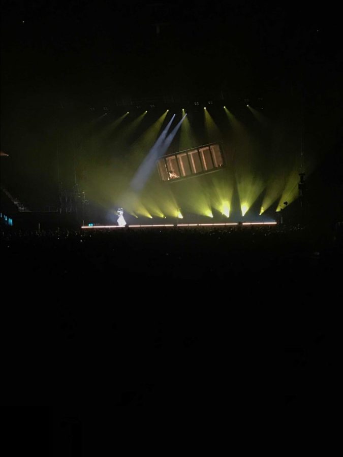 Lorde performing with the hanging box above her.