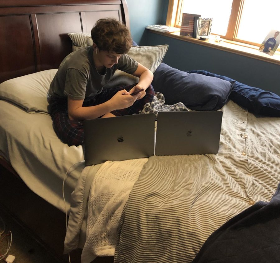 Sophomore Mitch Adams uses the Apple products Macbook Pro, Airpods and Iphone 8 while relaxing.
