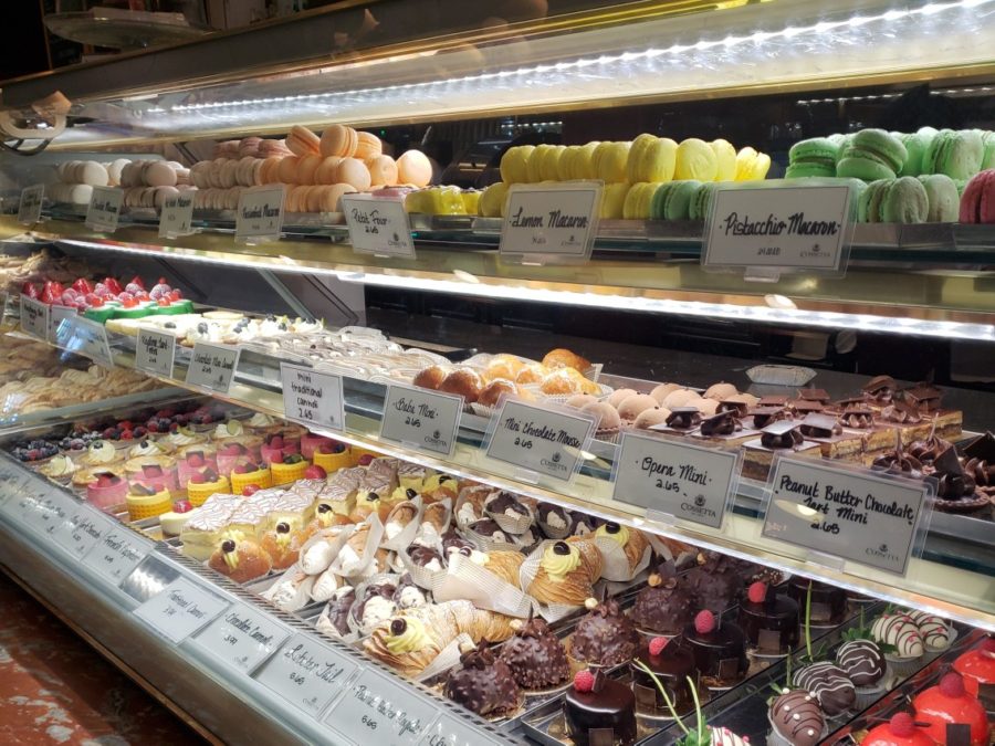 A display case full of ornately decorated pastries offered in Cossetta’s pasticceria.