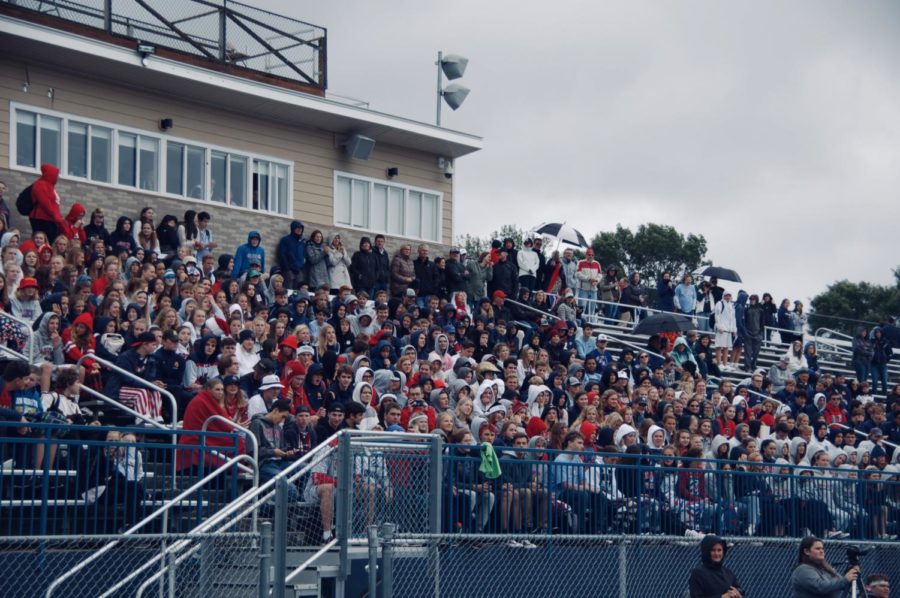 The+high+school+student+section+celebrates+the+Pep-Fest+and+Parade+on+Friday.