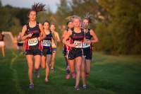 The girls cross country team running during a meet in 2018. 