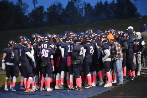 The Orono Football team huddles together tightly before the game.