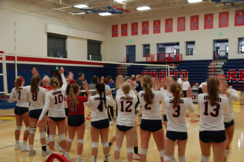 Players give each other congratulatory high fives after beating St. Anthony Village.