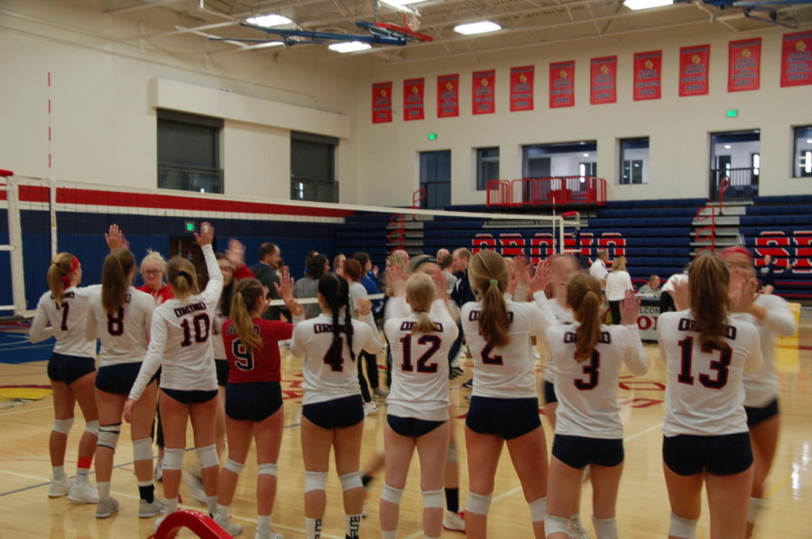 Players give each other congratulatory  high fives after beating St. Anthony Village.