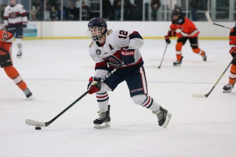 Junior no. 12 Jamie Bazil skates around his Delano opponents.