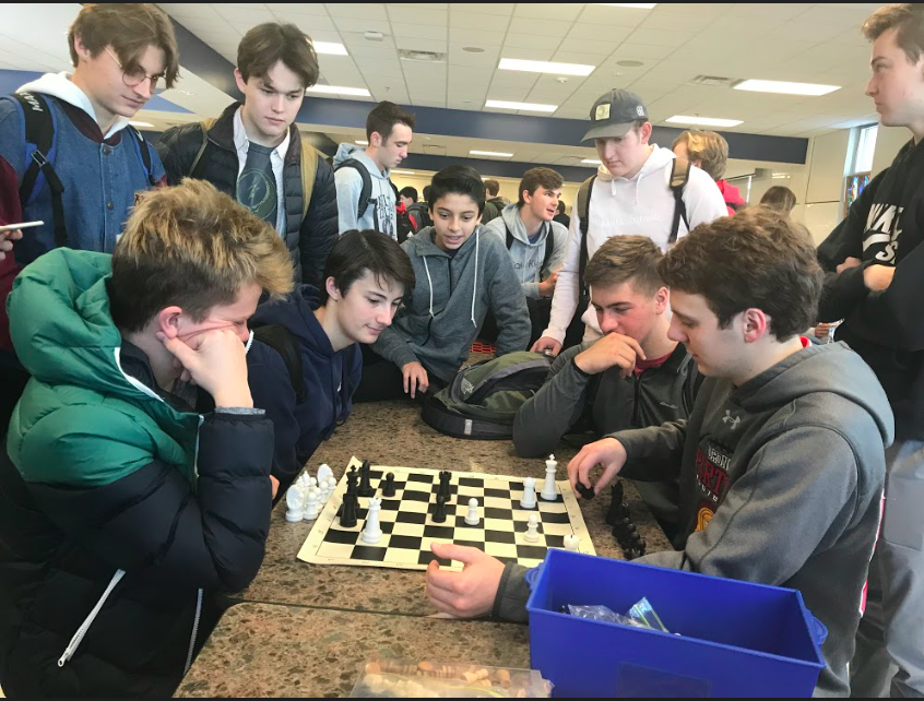 The+Chess+Club+gathers+around+seniors+Nick+Lewis%2C+Devin+Hunt%2C+Nick+Byrnes+and+Peter+Andrews.+