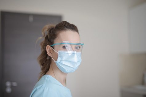 A healthcare worker wears a mask to protect from contracting the virus