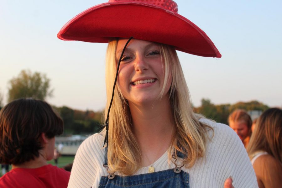 Senior Anna Moen is caught trying to balance a friend’s hat on her head at the Orono Homecoming football game.