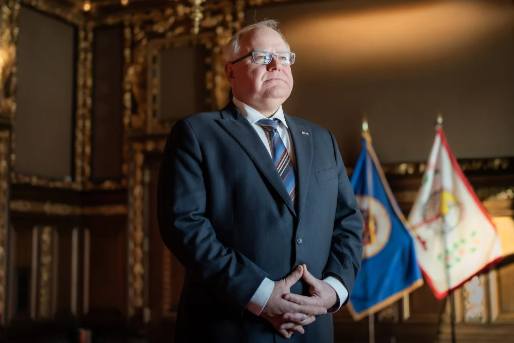 Minnesota Governor Tim Walz standing in the State Capitol.