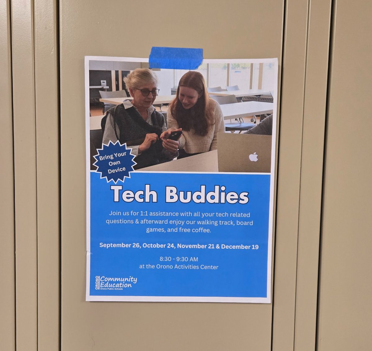 A Tech Buddies poster hangs on a locker.