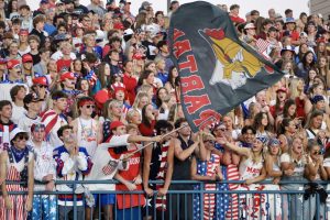 Orono student section waves Spartan flag.