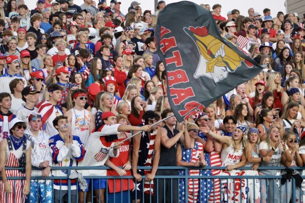 Orono student section waves Spartan flag.