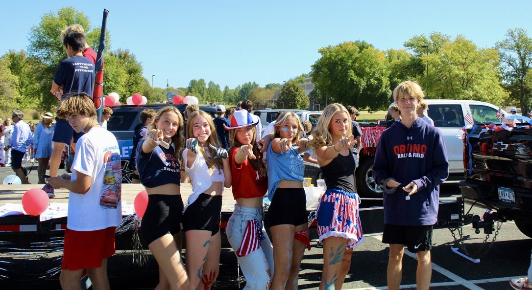 The Cross Country team poses in front of their parade float.