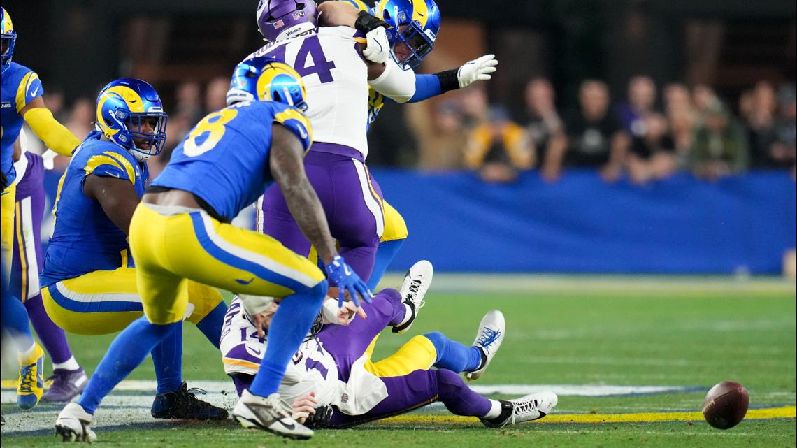 #8 Rams linebacker Jared Verse tries to grab the football following a fumble from #14 Vikings quarterback Sam Darnold.