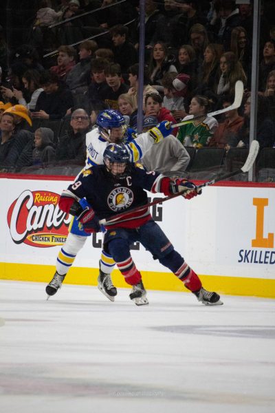 --- ducks under his opponents stick in a battle for the puck.