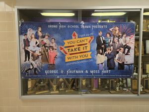 A poster hangs for the play "You Can't Take It With You"