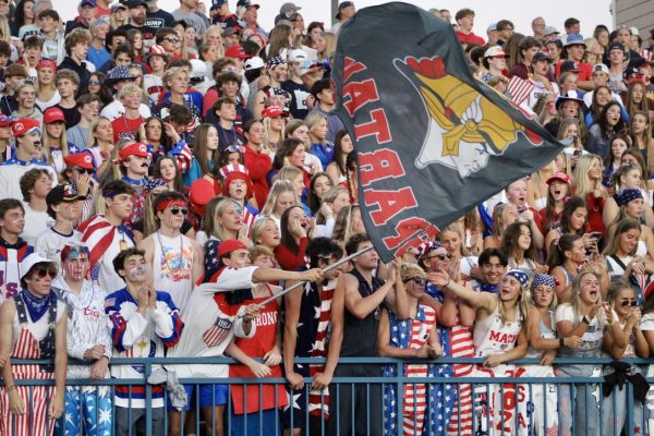The Orono student section waves a flag during the 2024 Homecoming Football game.