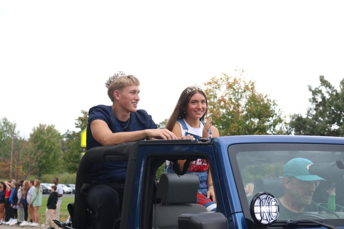 Homecoming King Dane Kanwischer and Queen Ariah Ragan ride in the parade.