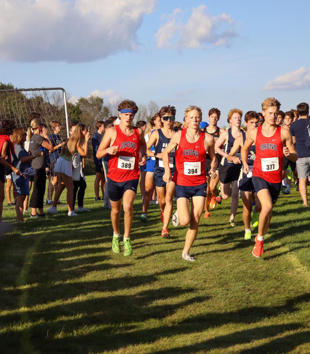Sophomore Eddy Loberg, senior Cooper Munsch, and senior Gabe Hallen lead the race at the Twilight 5K.