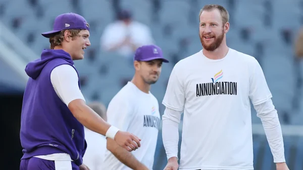Vikings quarterbacks J.J. McCarthy and Carson Wentz warming up