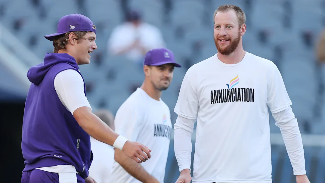 Vikings quarterbacks JJ McCarthy and Carson Wentz warming up