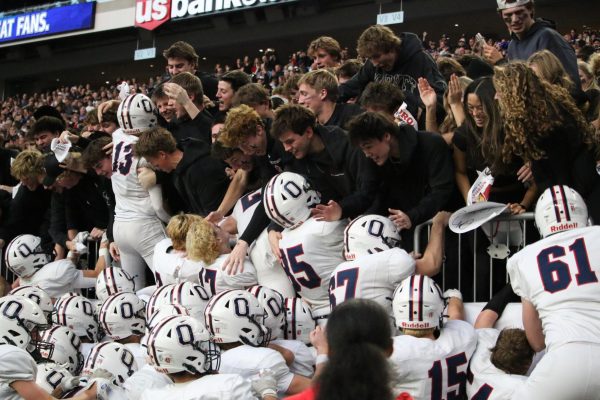 The Orono student section and the football team celebrate after winning the game.