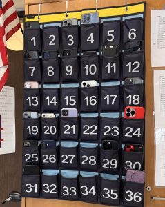 Students’ phones are placed in the phone pockets.